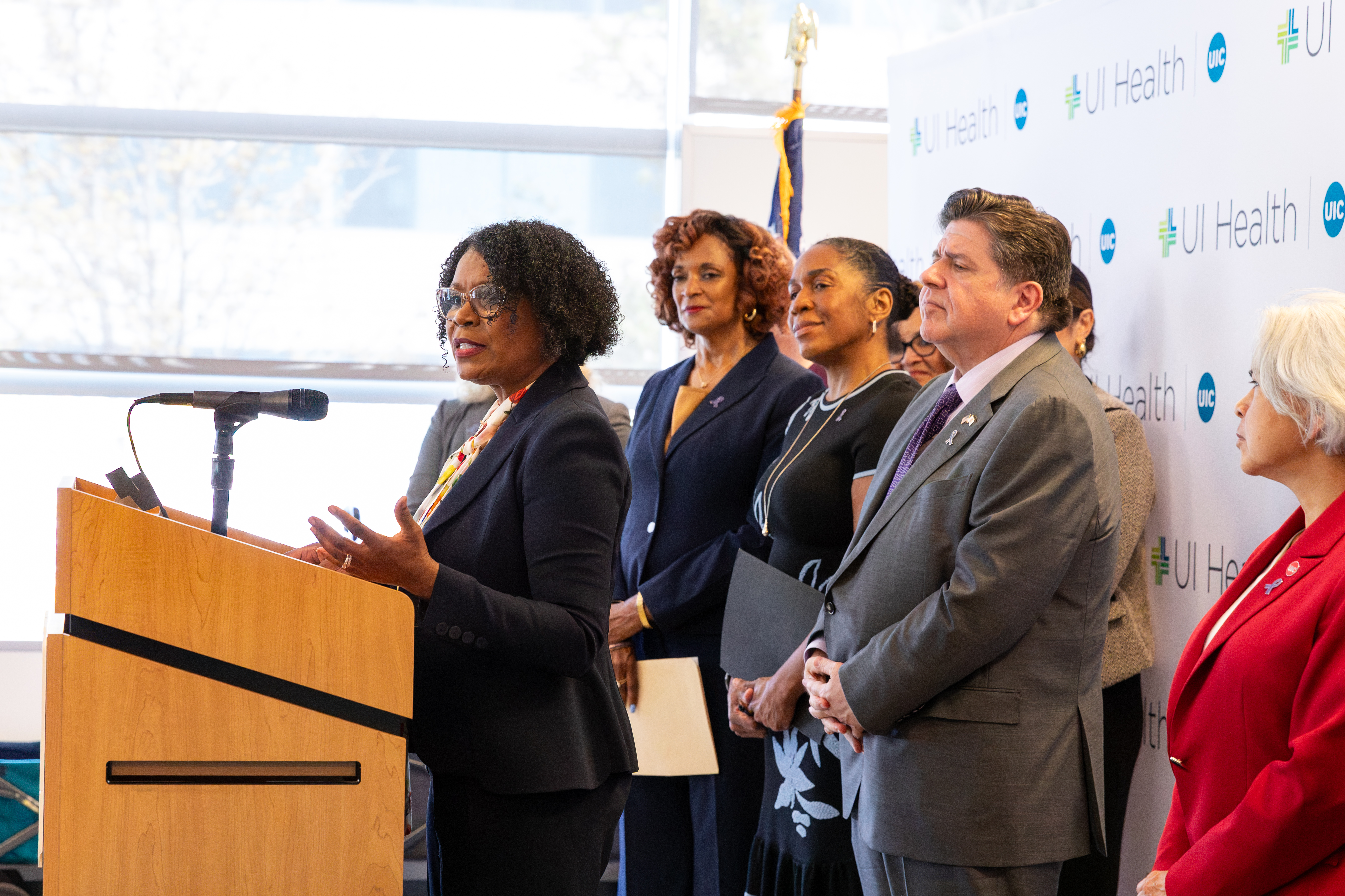 State Senator Adriane Johnson speaks at a podium